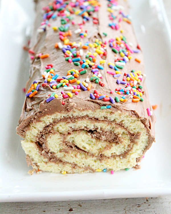 Vanilla Roll Cake with Chocolate Frosting #rollcake #vanillacake #dessert #chocolate #frosting #chocolatefrosting #tableforsevenblog 