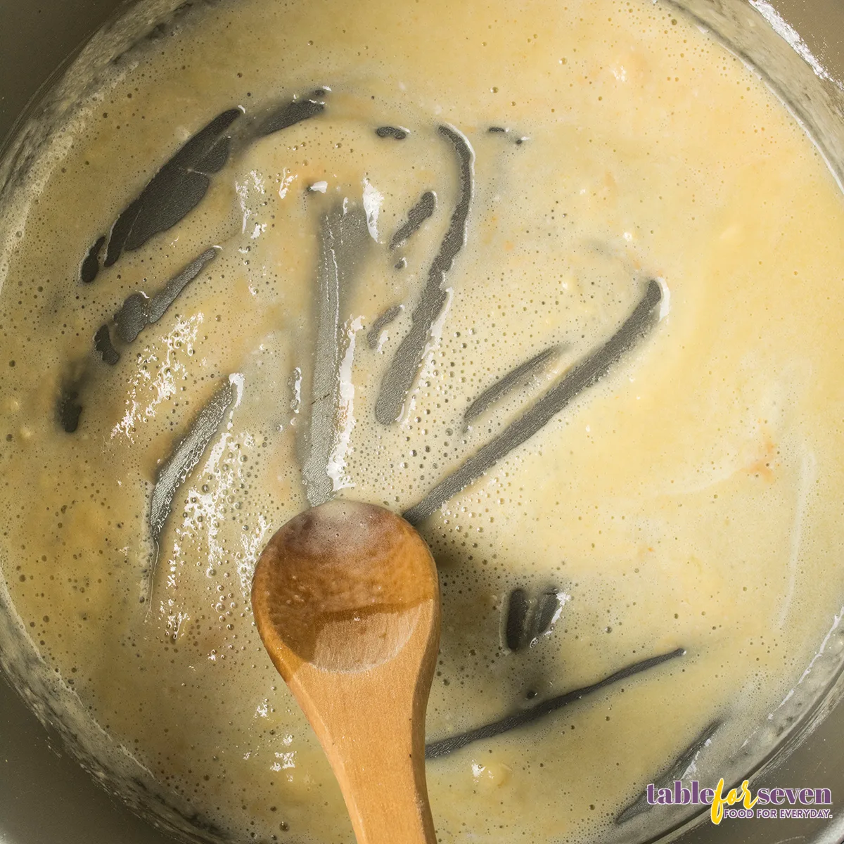 Butter and flour roux being stirred to create the base for a creamy sauce.