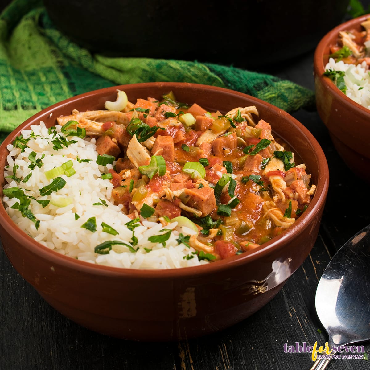 Chicken and sausage gumbo served in a brown bowl with rice