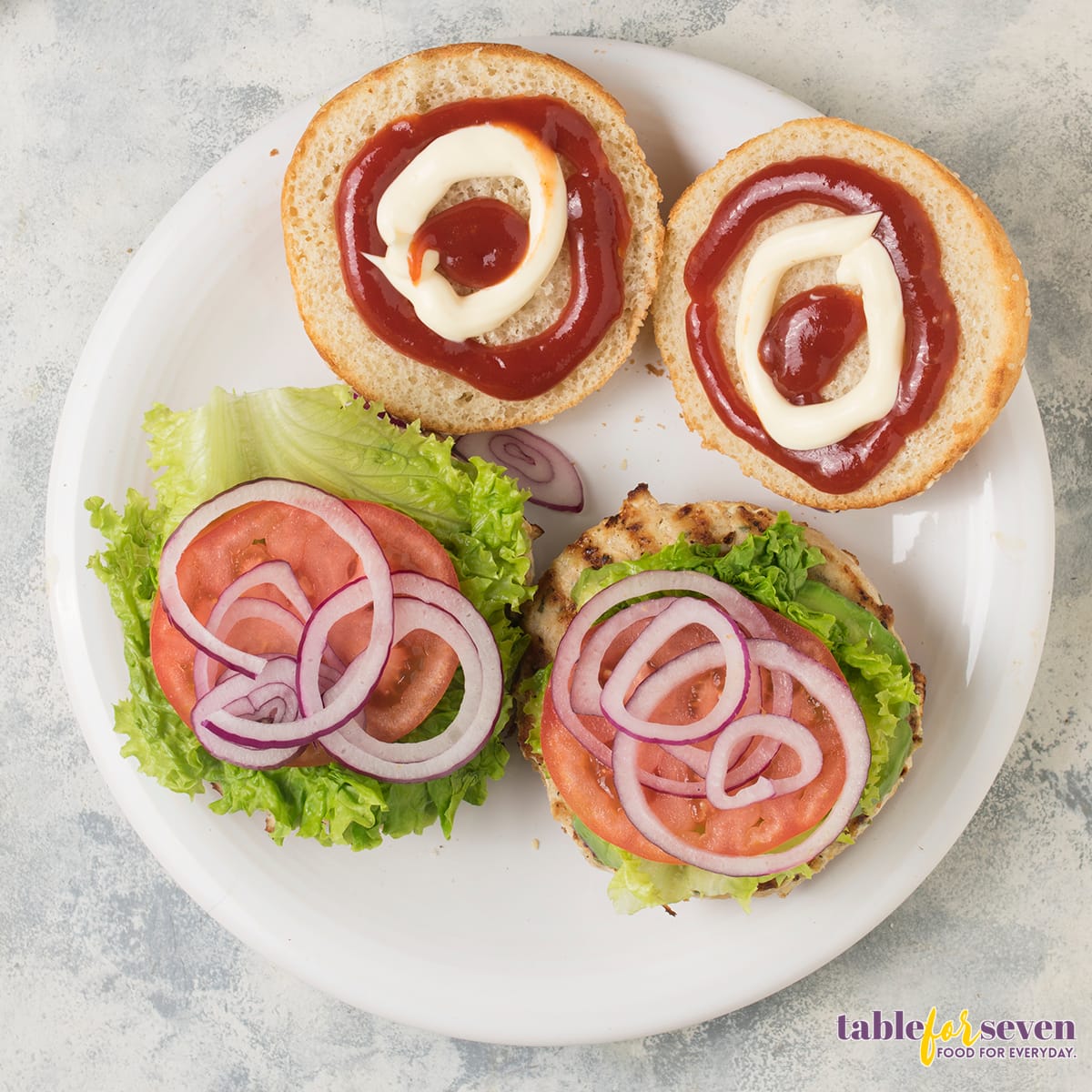 Sesame seed burger buns with ketchup and mayonnaise swirls