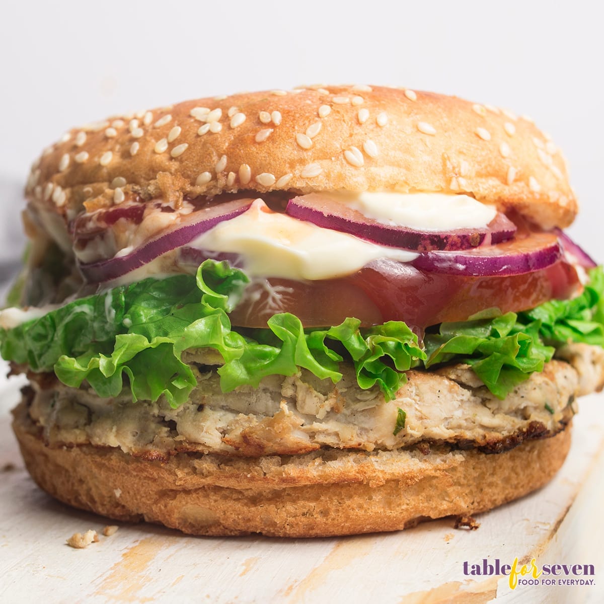 Close-up of assembled turkey burger with fresh lettuce and tomato