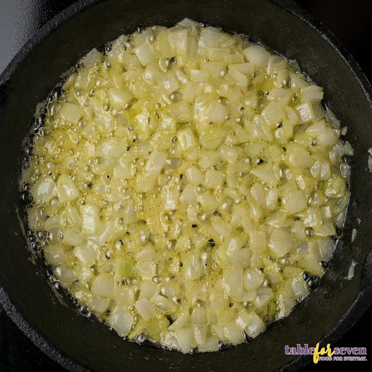 Sautéing diced onions in butter for the chicken pot pie base