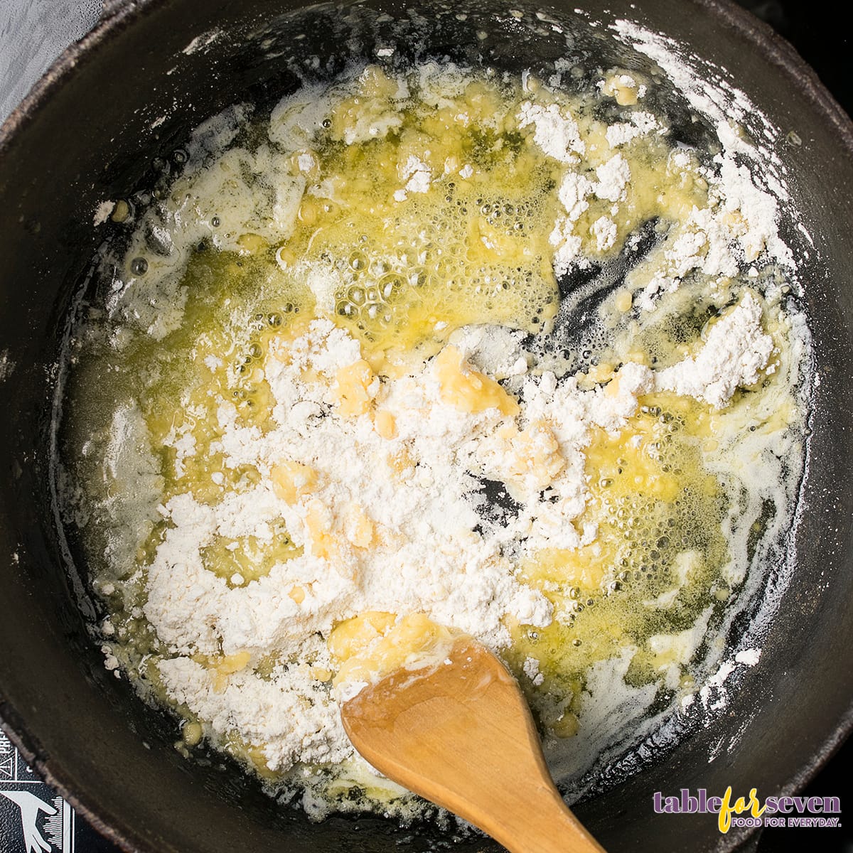 Butter and flour roux cooking in a skillet for gumbo preparation