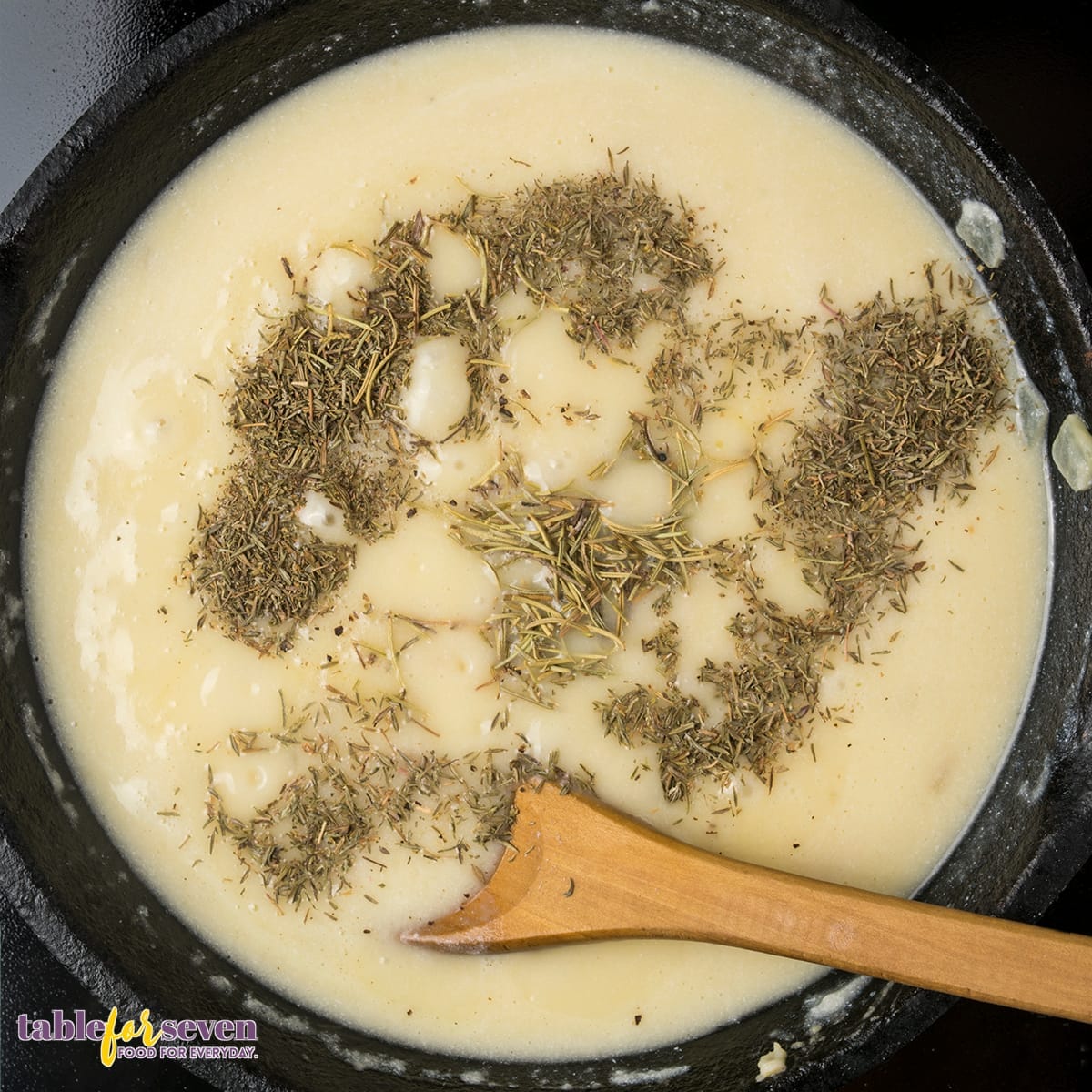 Adding herbs and seasonings to the creamy sauce