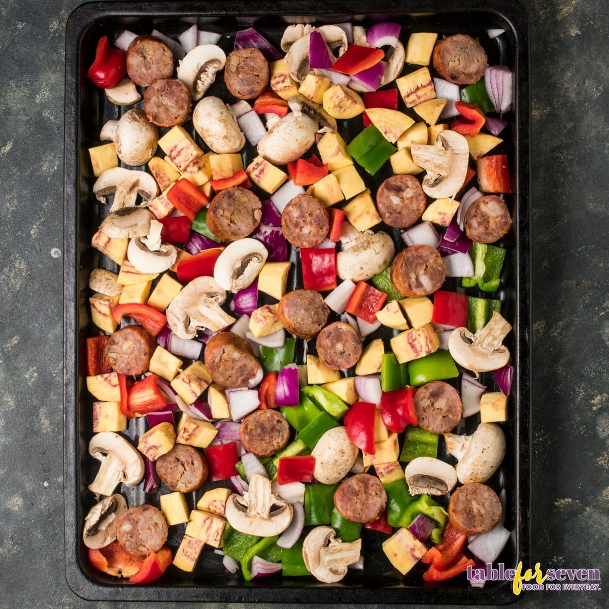 Sausage and vegetable sheet pan ready for baking