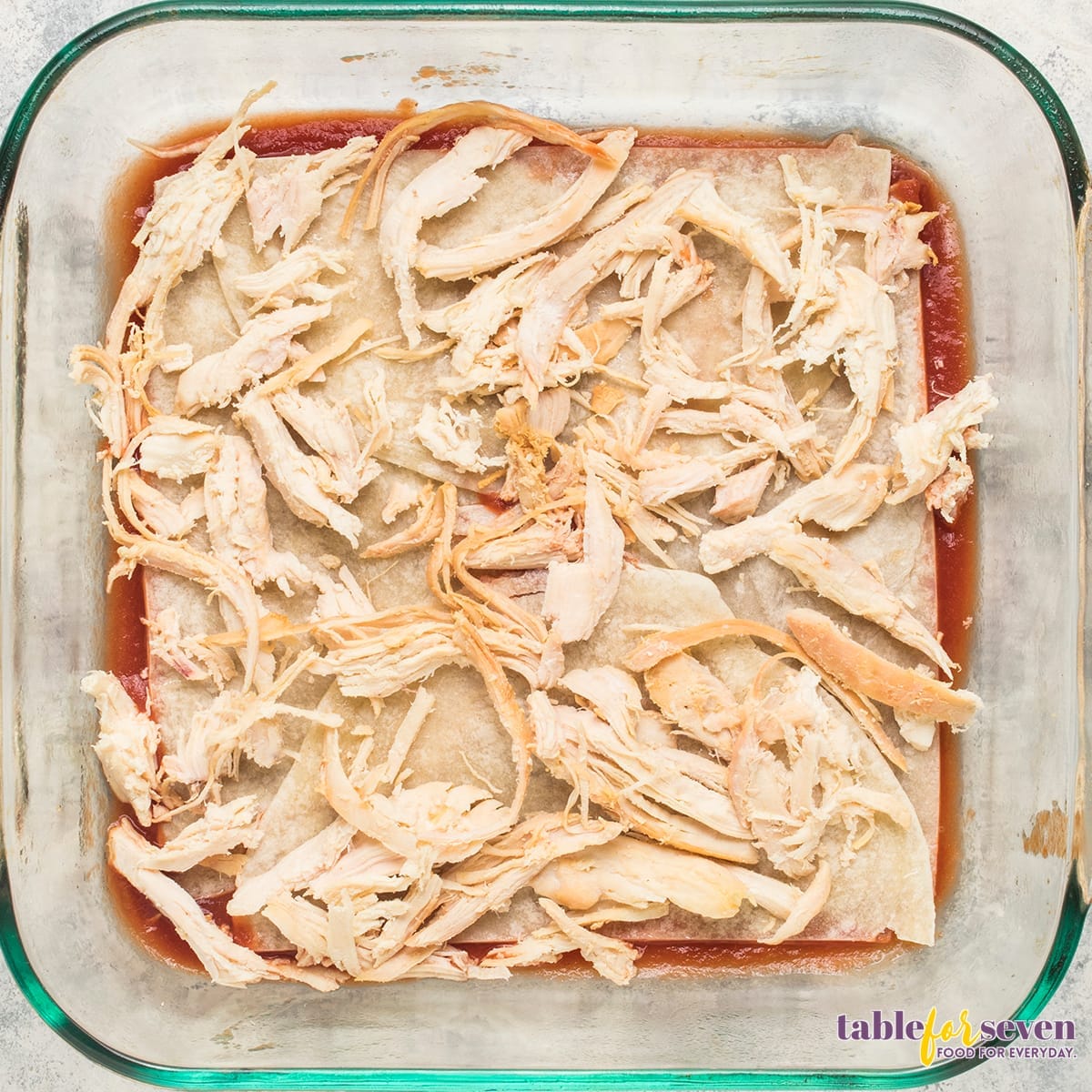 Shredded Chicken on Tortillas for Enchilada Casserole