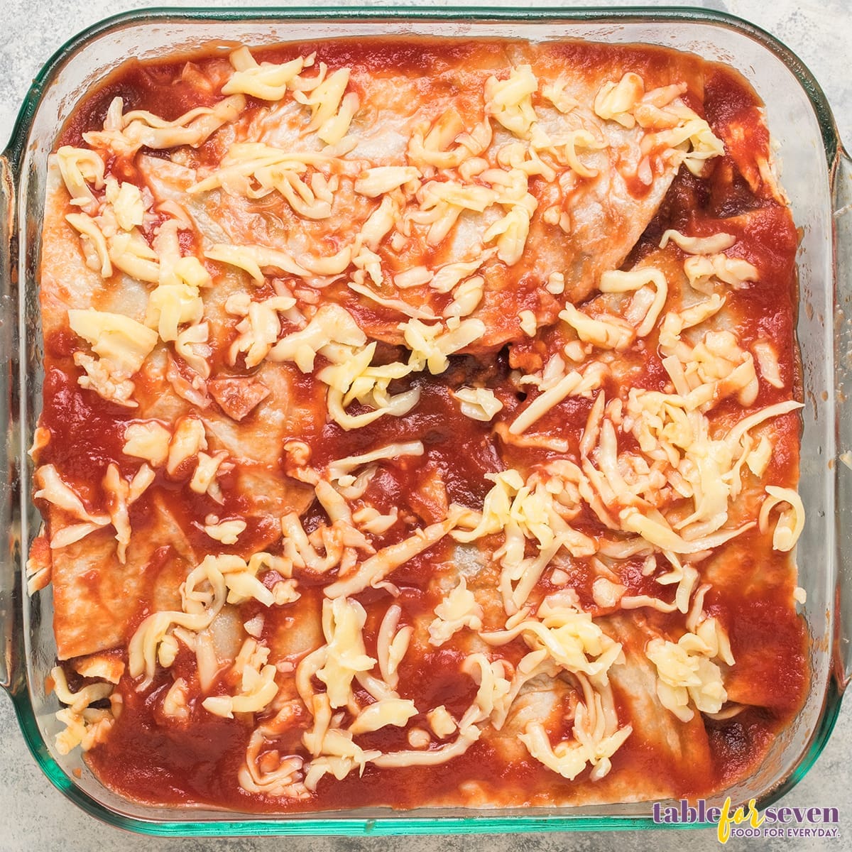 Final Layer of Cheese and Sauce on Chicken Enchilada Casserole