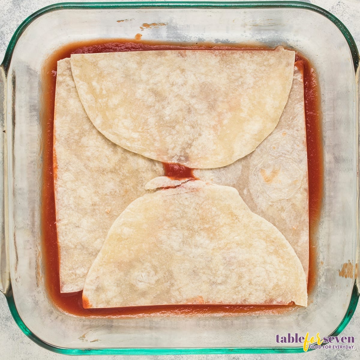 Layer of Tortillas in Chicken Enchilada Casserole Preparation