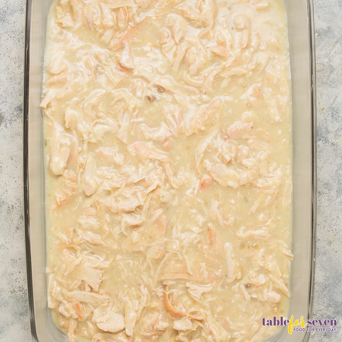 Creamy chicken mixture spread in the baking dish for Pioneer Woman Chicken and Dressing Casserole