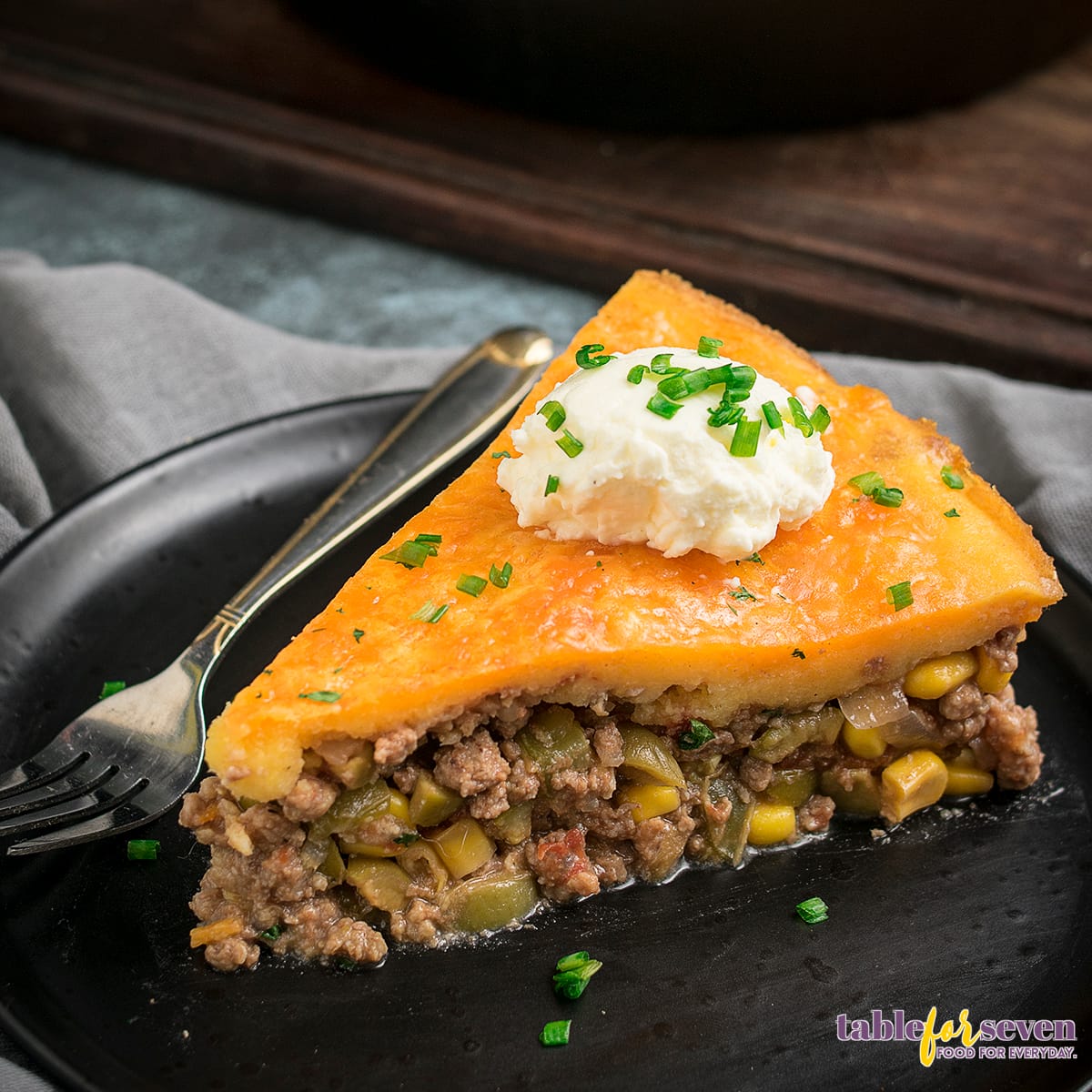 Tamale pie served in a black plate