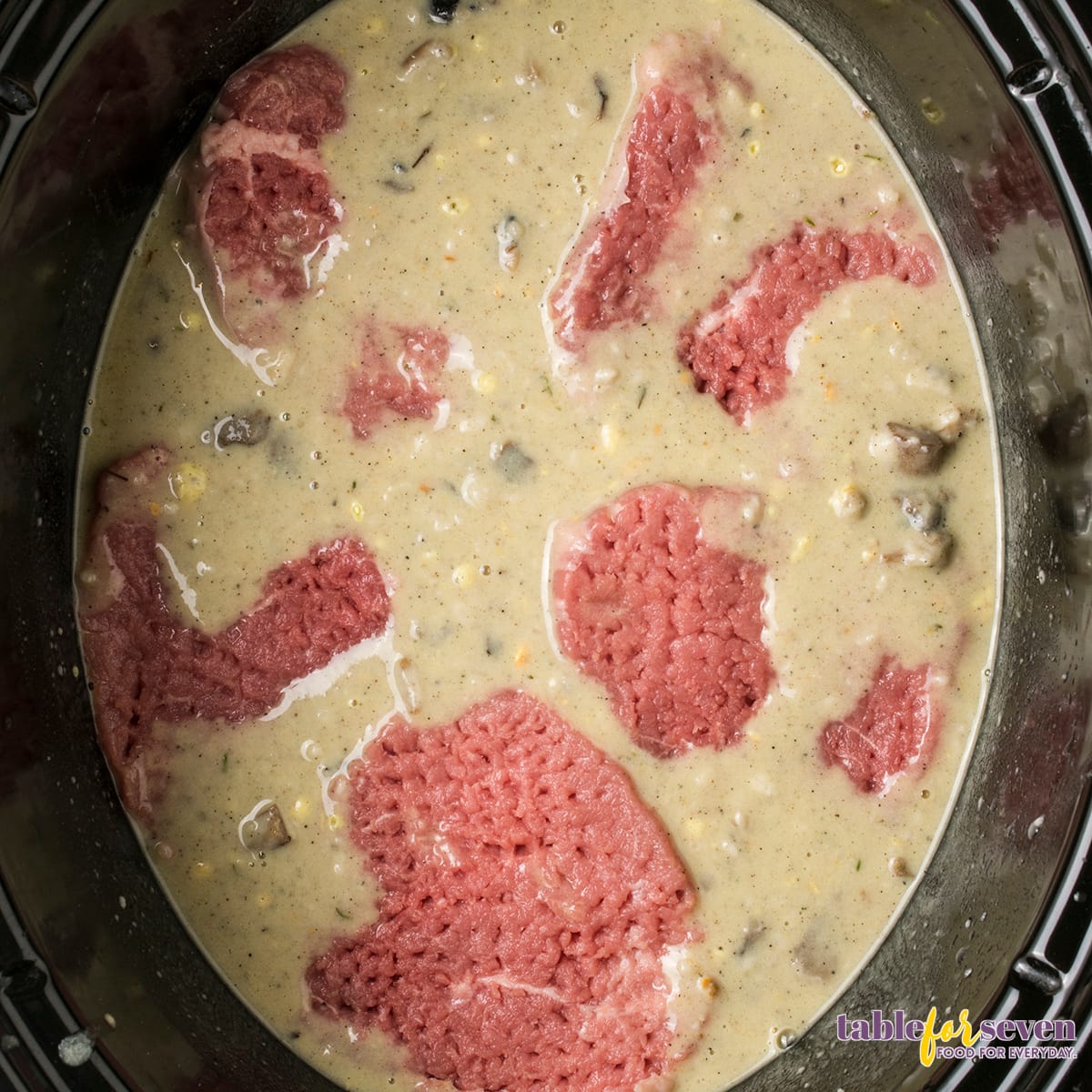 Tender raw cube steaks prepared for slow cooking in a Crock Pot