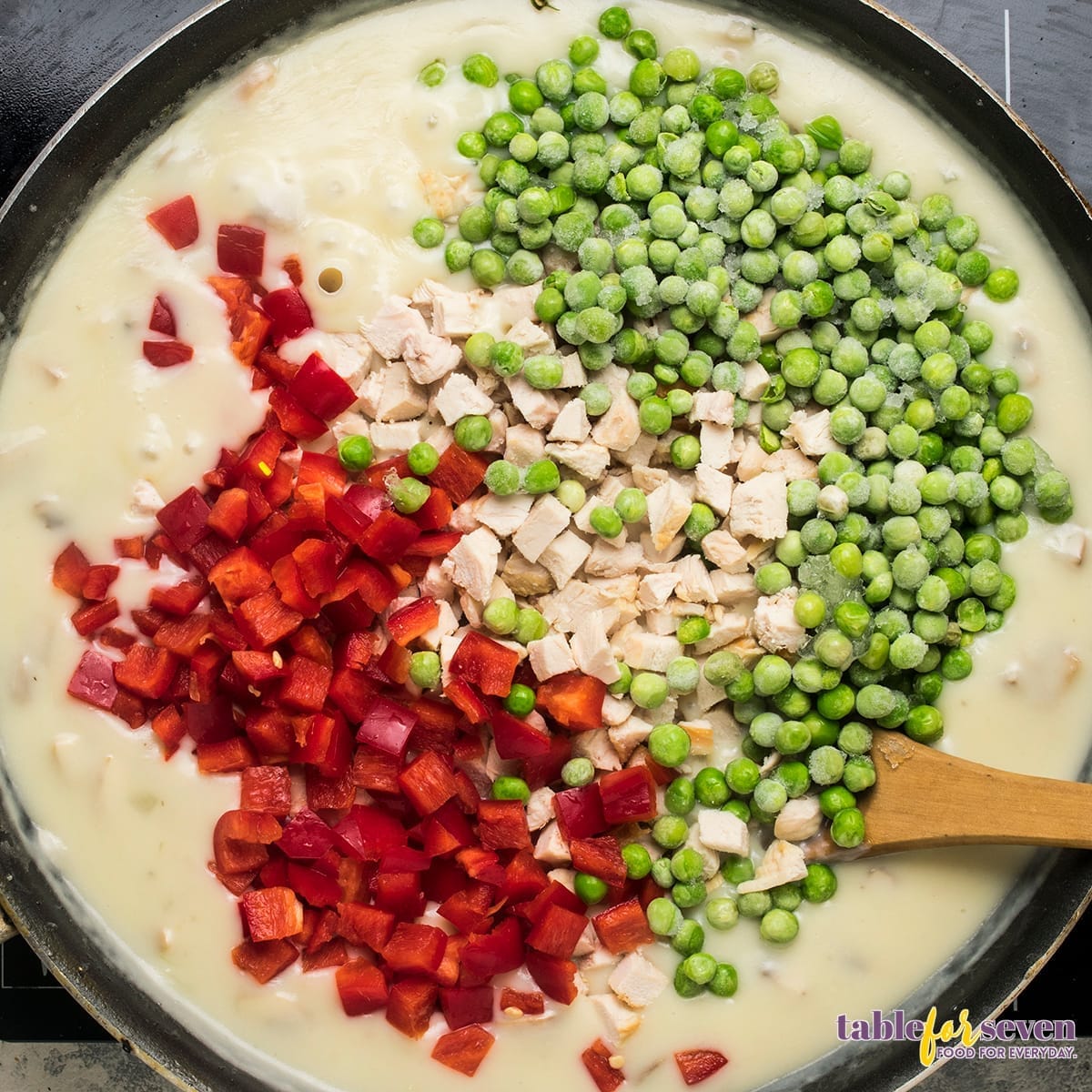 Mix of peas, red bell pepper, and cooked chicken added to creamy sauce for Chicken Ala King