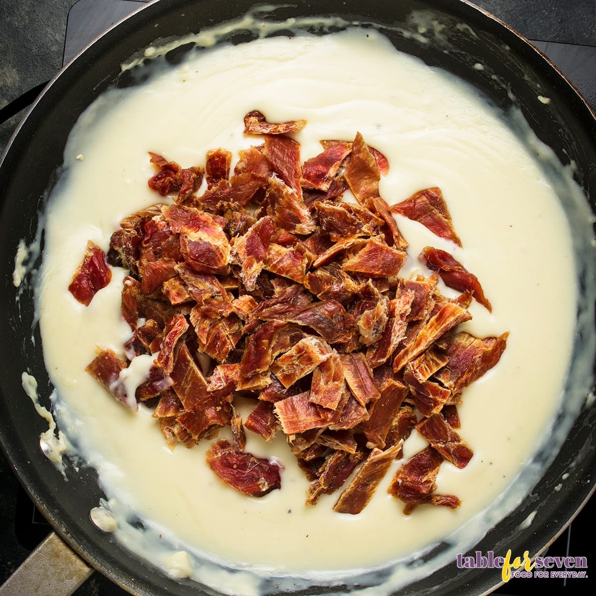 Shredded dried beef added to creamy sauce