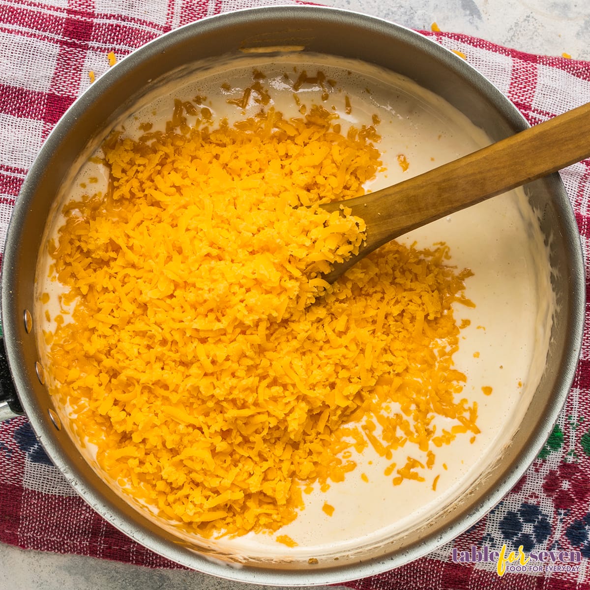 Grated cheddar cheese added to the cream mixture for chicken divan