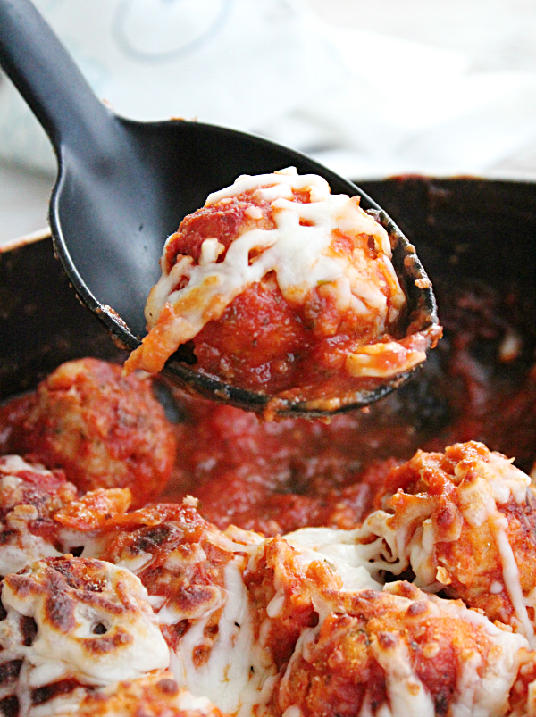 Cheesy Skillet Meatballs on a spoon