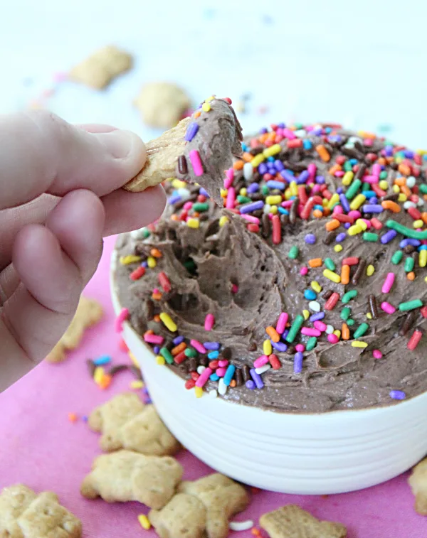 Dipping a cracker in Cake Batter Dip