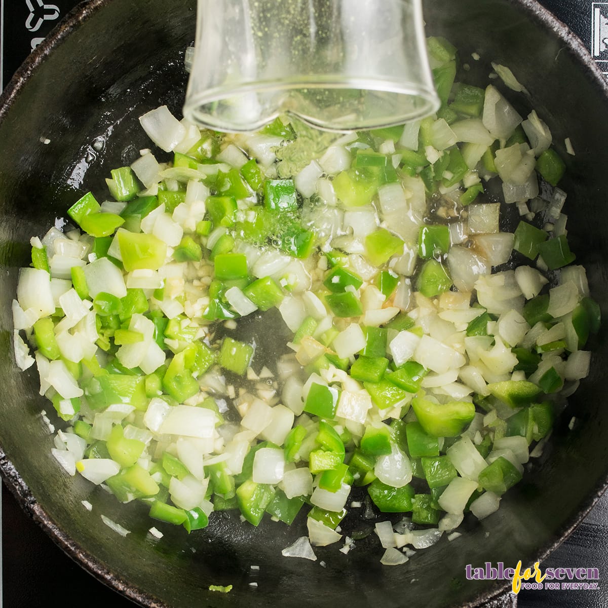 Chicken Cacciatore broth with herbs and seasonings cooking in a skillet