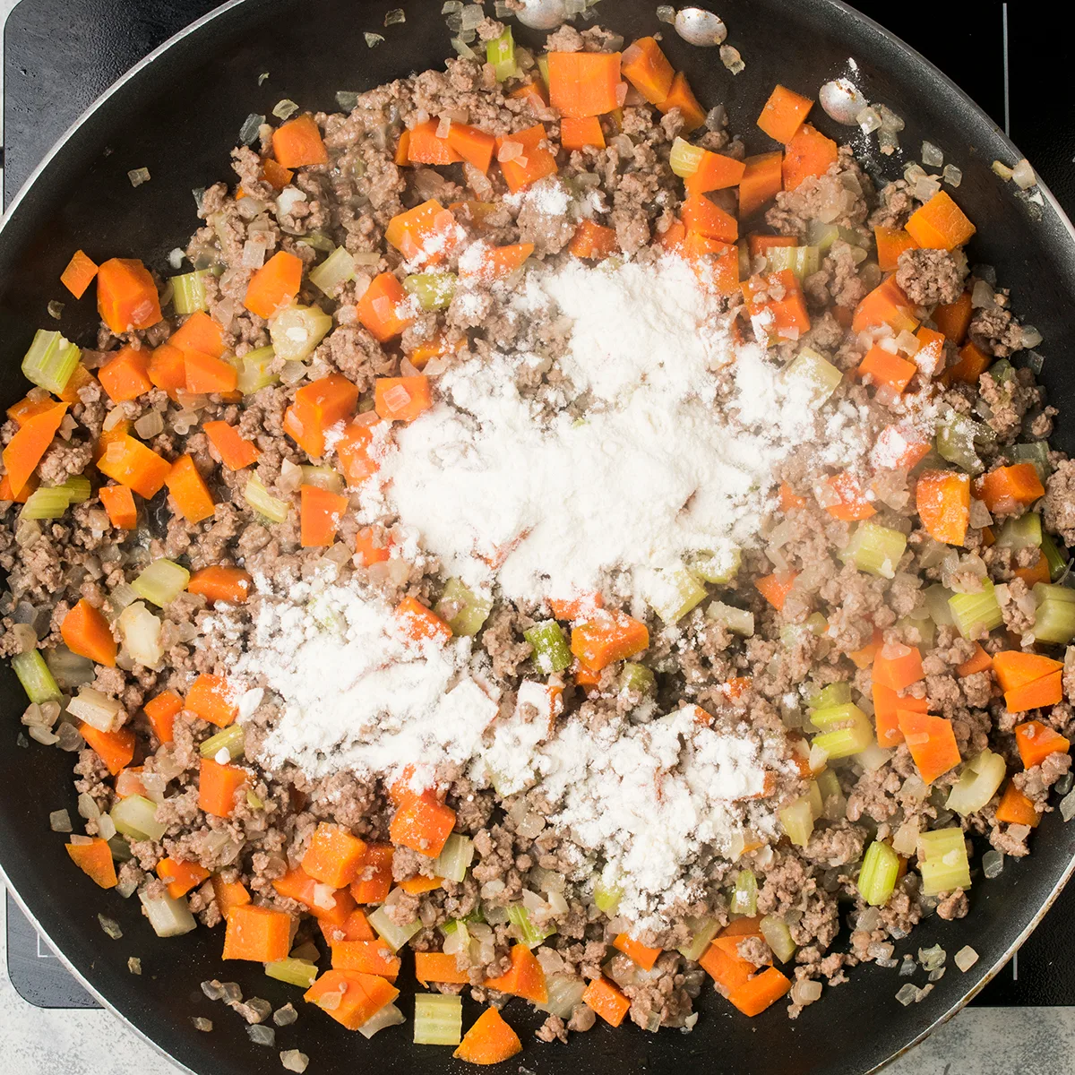 Adding flour for the cottage pie filling
