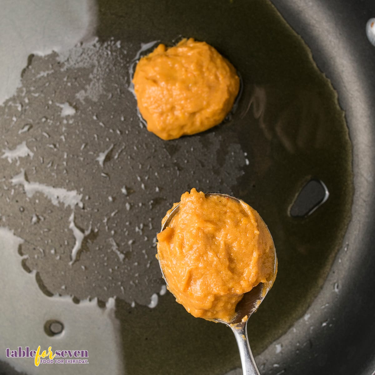 Sweet potato jack batter frying in a skillet with olive oil