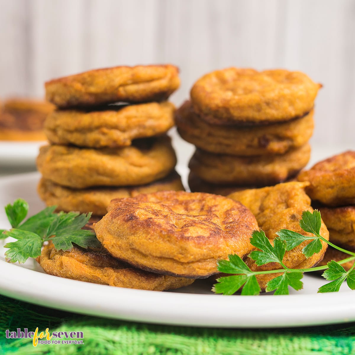 Sweet potato jacks stacked on a plate, garnished with parsley