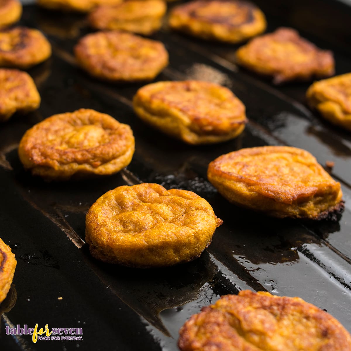 Sweet potato jacks baked and arranged on a baking sheet