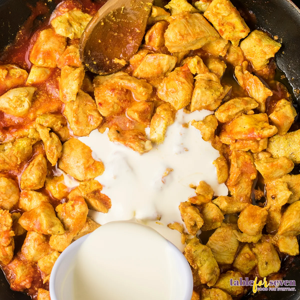 Adding cream to butter chicken sauce