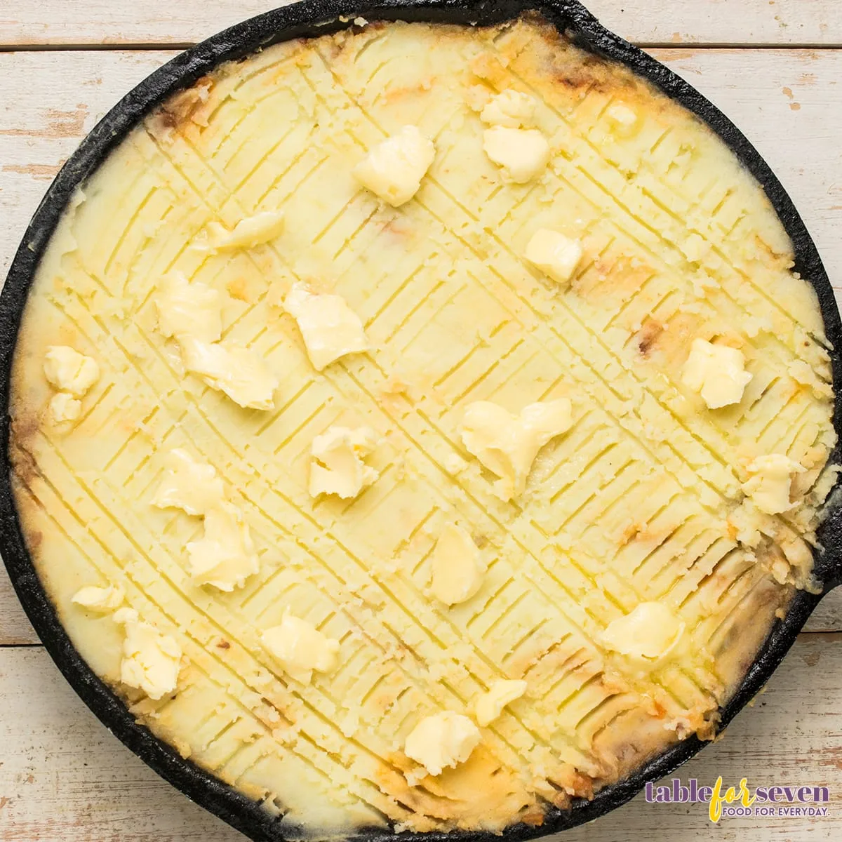 Cottage Pie topped with butter pats before baking