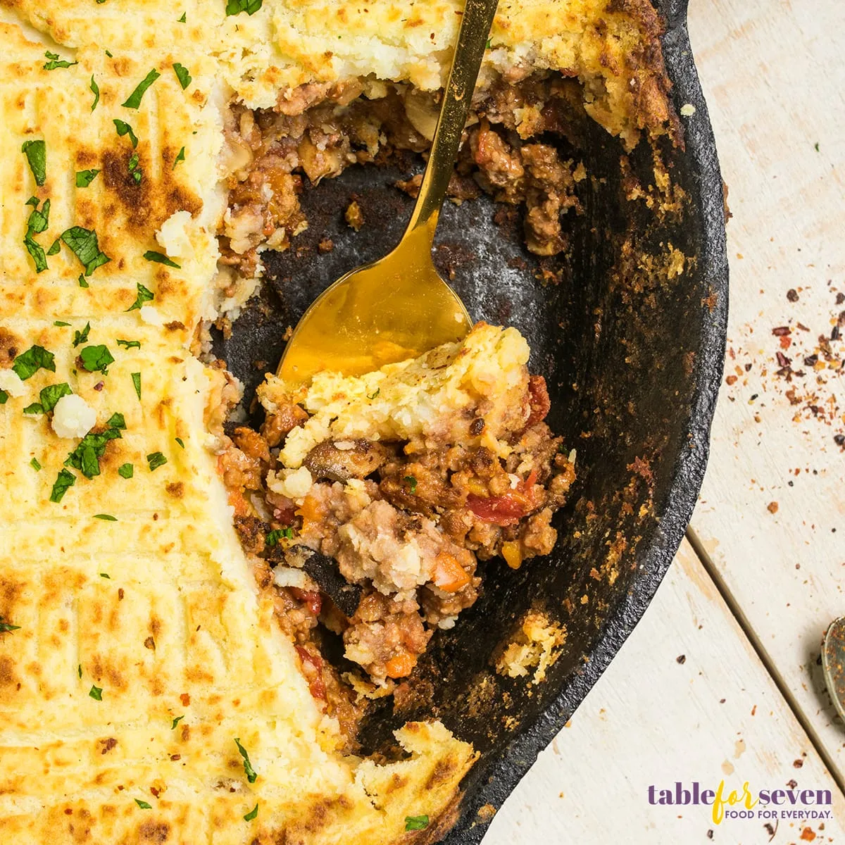 Serving of Cottage Pie with a golden spoon