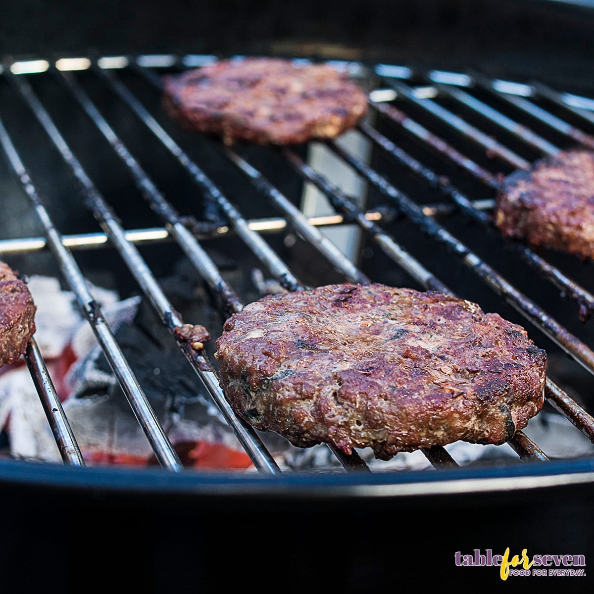 Gordon Ramsay Lamb Burgers cooking on a charcoal grill