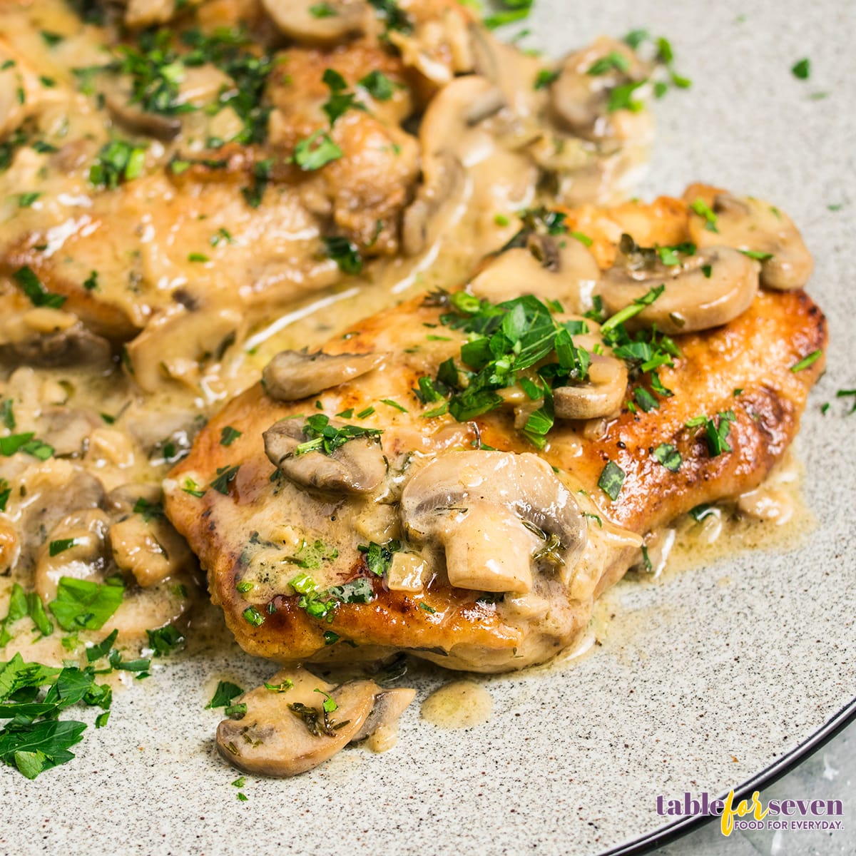 Marsala chicken on a plate with mushrooms and sauce