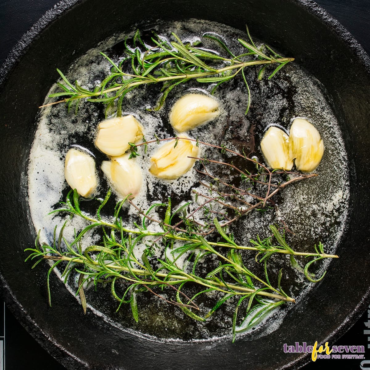 Garlic and rosemary sautéing in a skillet