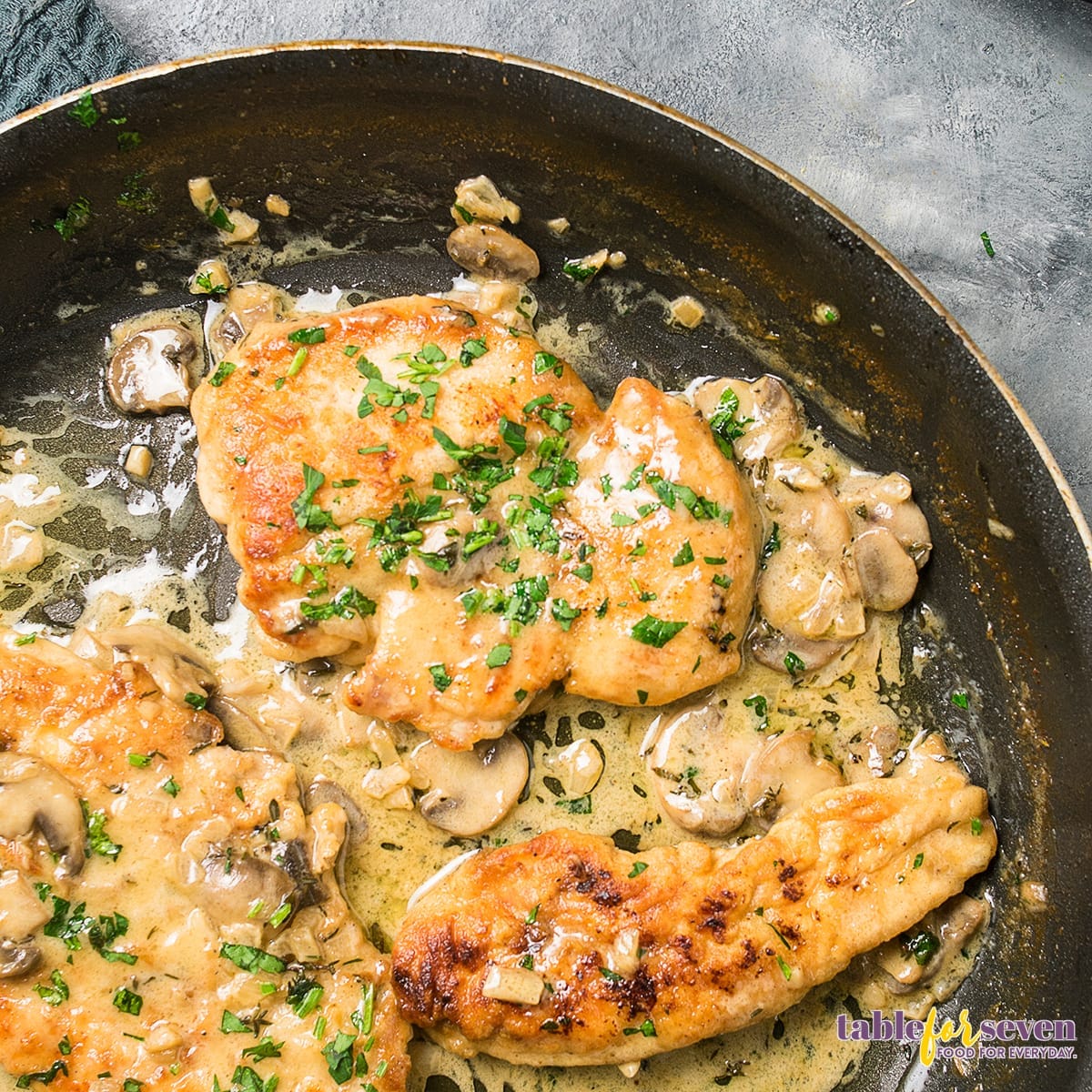 Marsala chicken cooking in a skillet