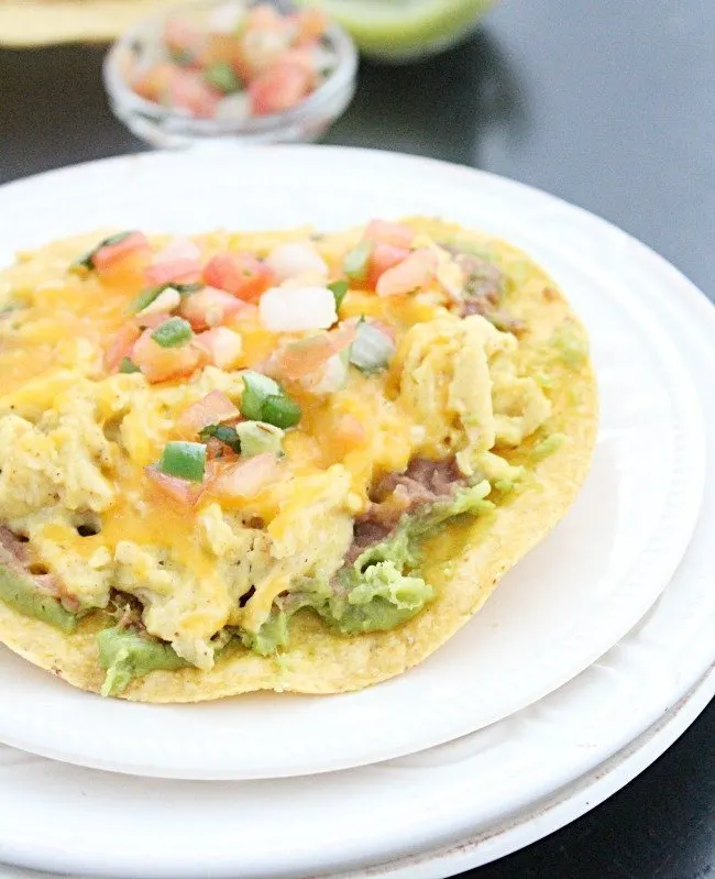 Breakfast Tostadas #tostada #breakfast #eggs #guacamole #tomatoes #cheese #tableforsevenblog